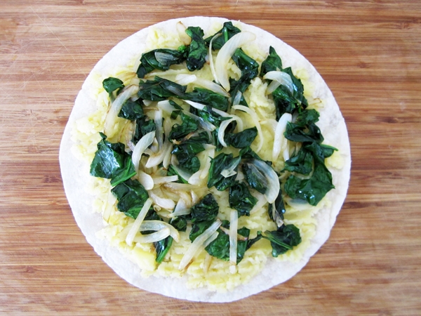 Spinach, onions, mashed potato on tortilla
